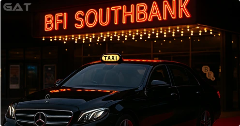 Black Mercedes saloon taxi parked outside BFI Southbank during the London Film Festival with red carpet banners and festival lights