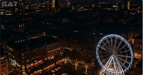 Manchester skyline illuminated with Christmas lights and Ferris wheel during festive season