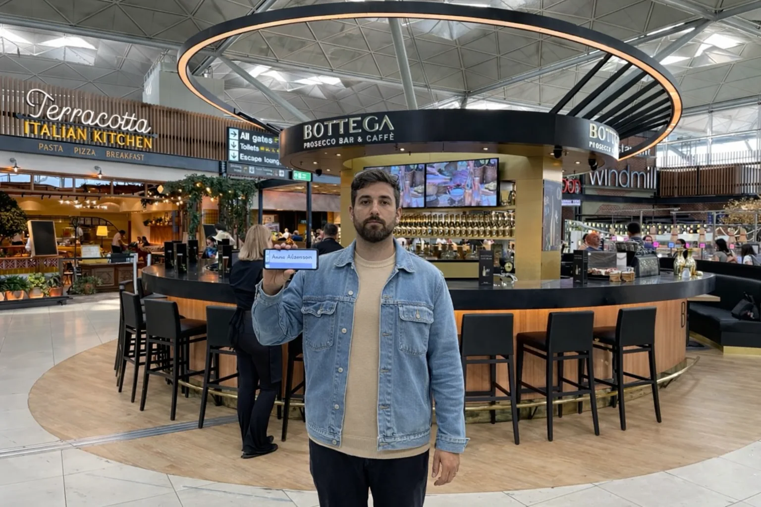 drievr with name board at Stansted Airport terminal