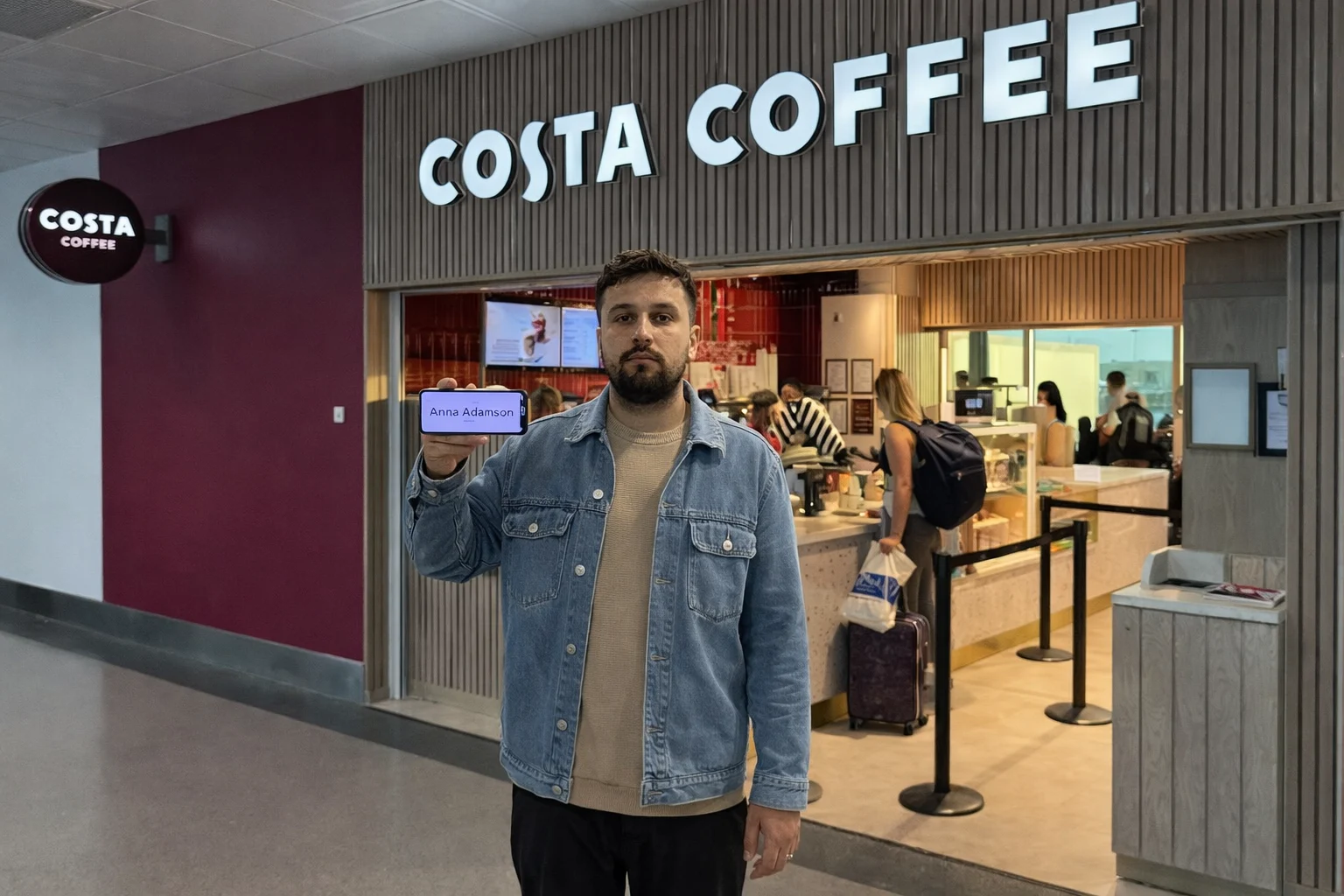 driver with name board at Stansted Airport terminal