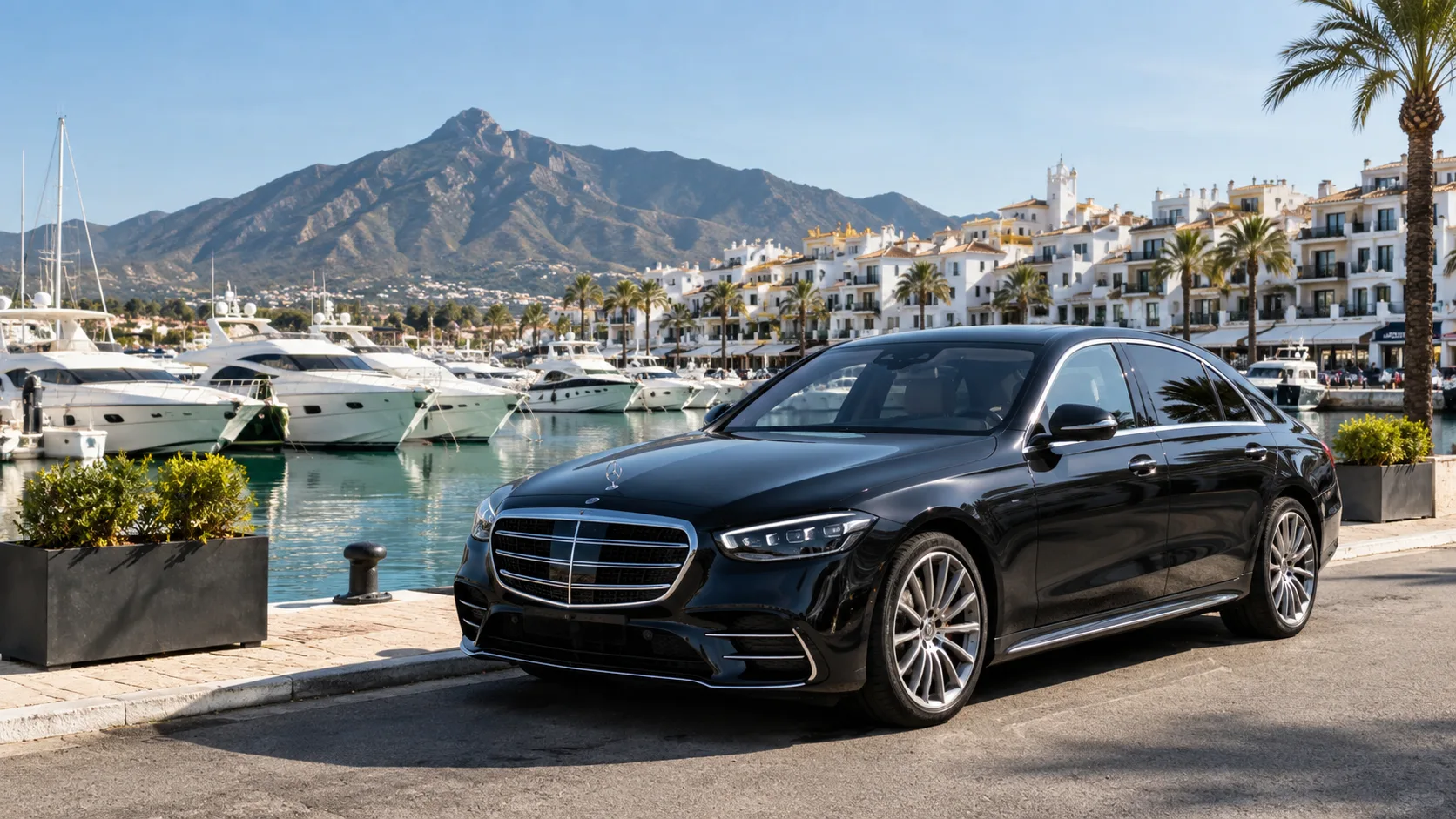 Black executive taxi beside Puerto Banús marina for a Malaga Airport to Puerto Banus taxi transfer.